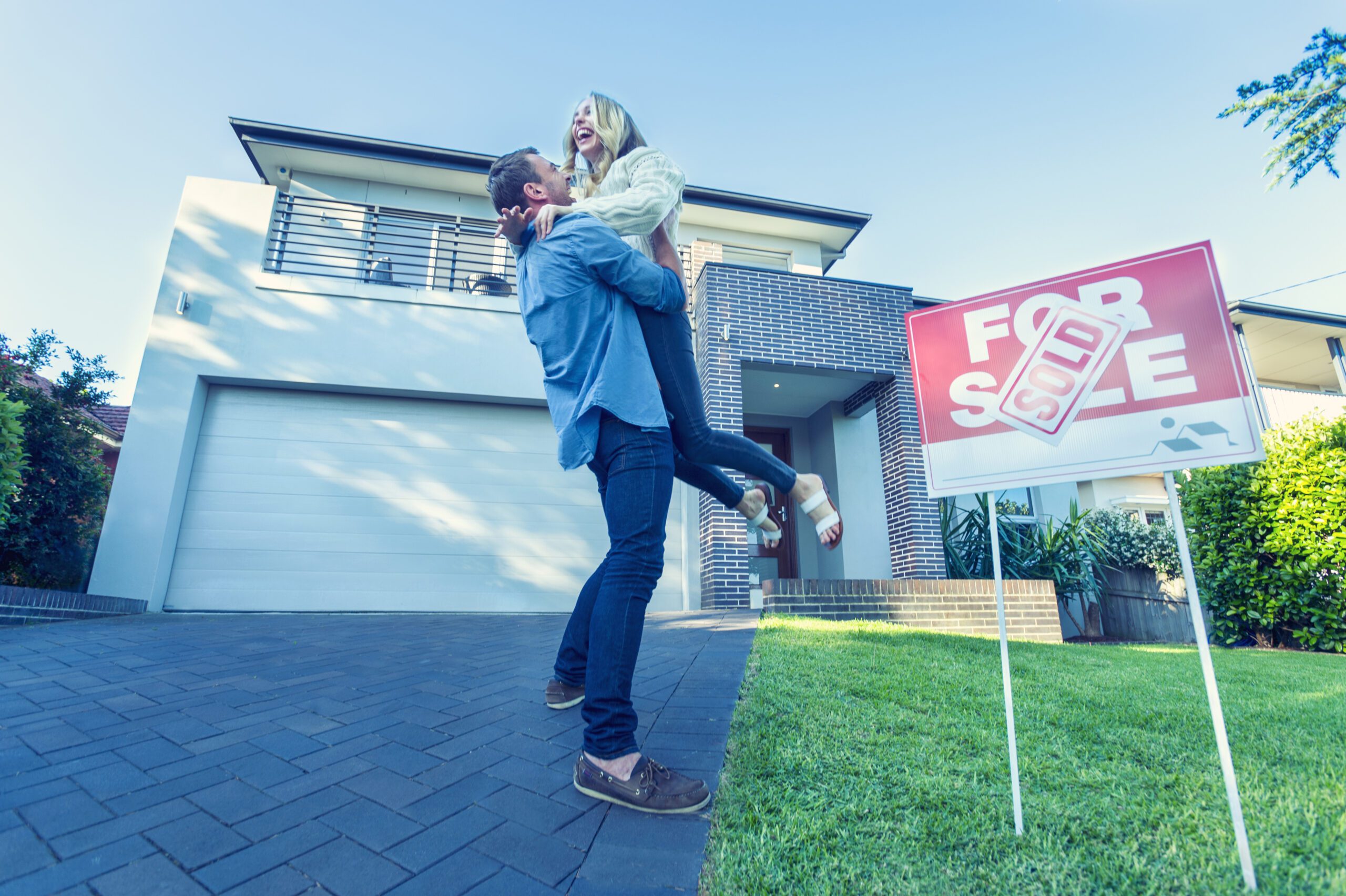 Couple standing in front of a new home