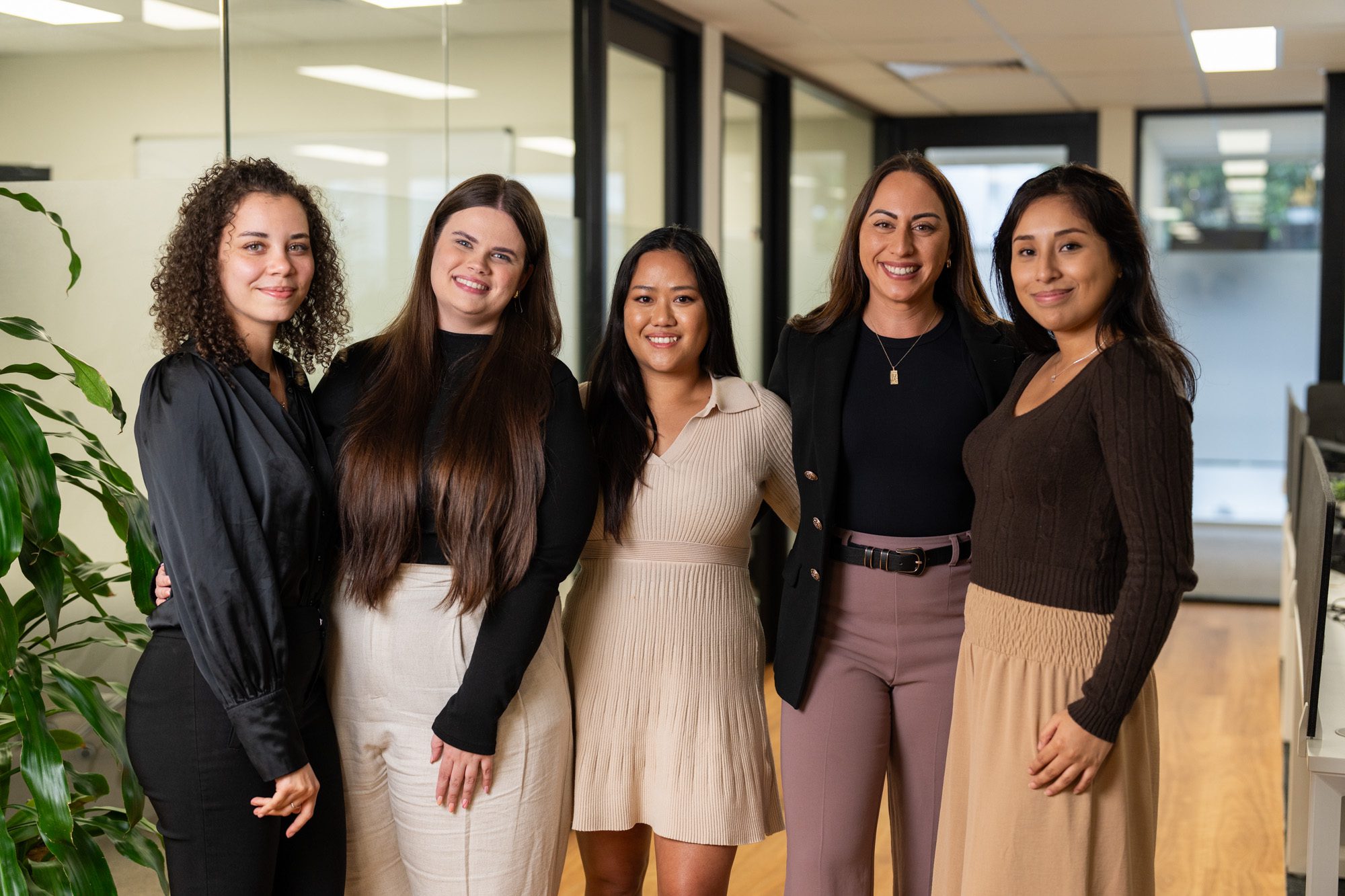 5 female professionals smiling