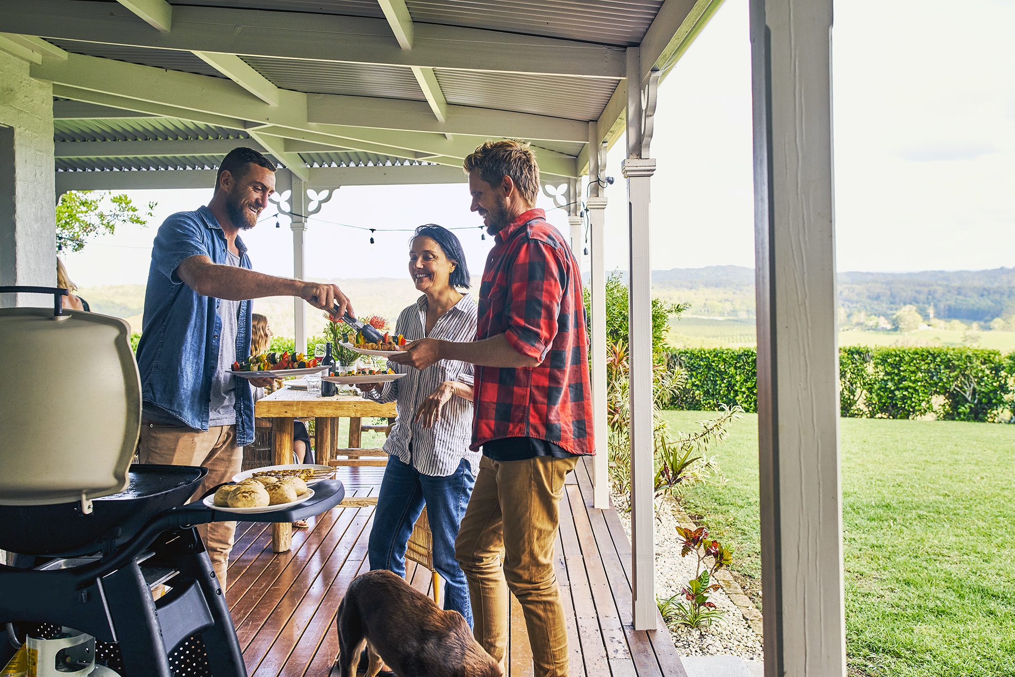 Shot of people getting food fresh off the braai